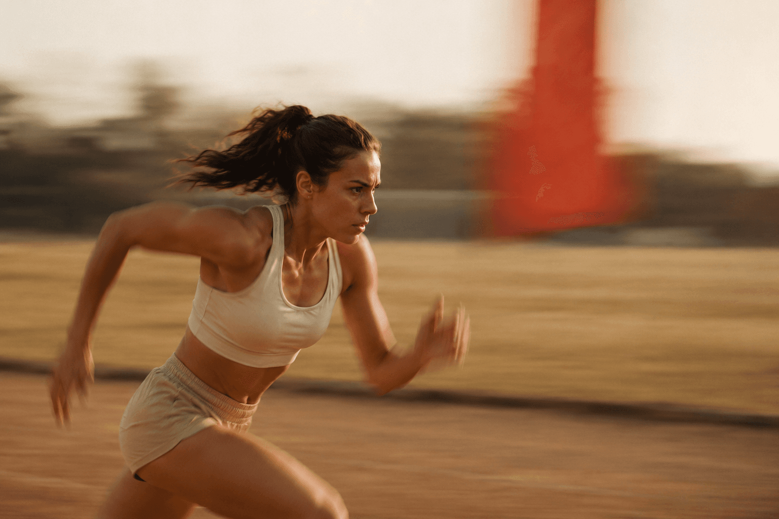 Runner accelerating on a warm track near an entry window